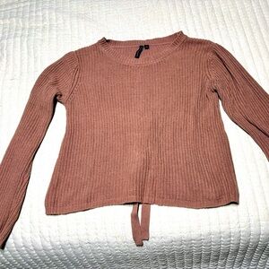 Pink sweater with tie back.